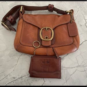 Coach small shoulder bag with matching wallet in a cognac color.